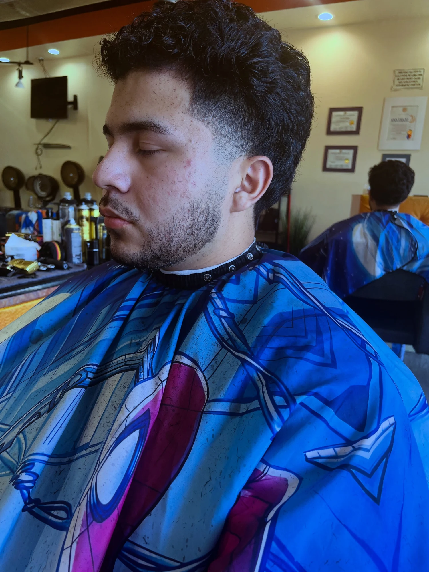Full curls above Greg’s blended fade